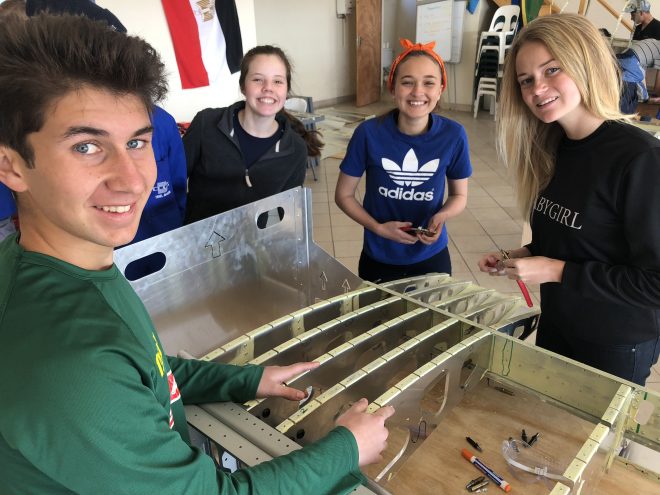 Teenagers building plane