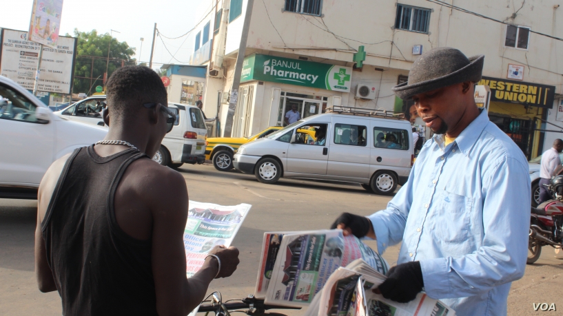 Gambians reading the news paper